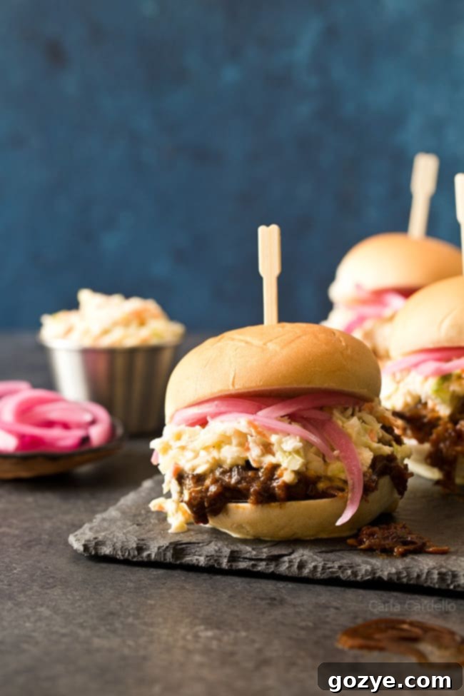 Delicious Slow Cooker Shredded Beef Sliders with homemade barbecue sauce and coleslaw