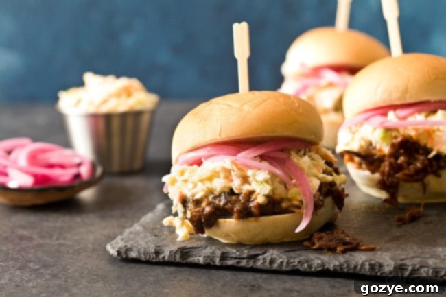 Close-up of Slow Cooker Shredded Beef Sliders with homemade coleslaw
