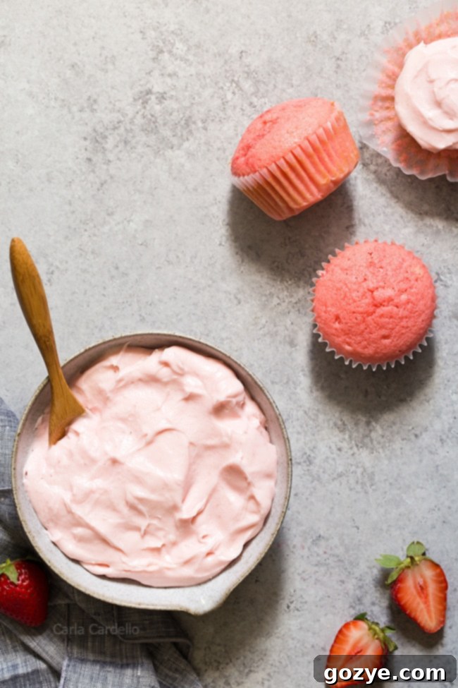 Strawberry Cream Cheese Frosting swirled on strawberry cupcakes