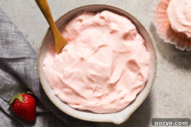 Close up view of smooth, pink Strawberry Cream Cheese Frosting