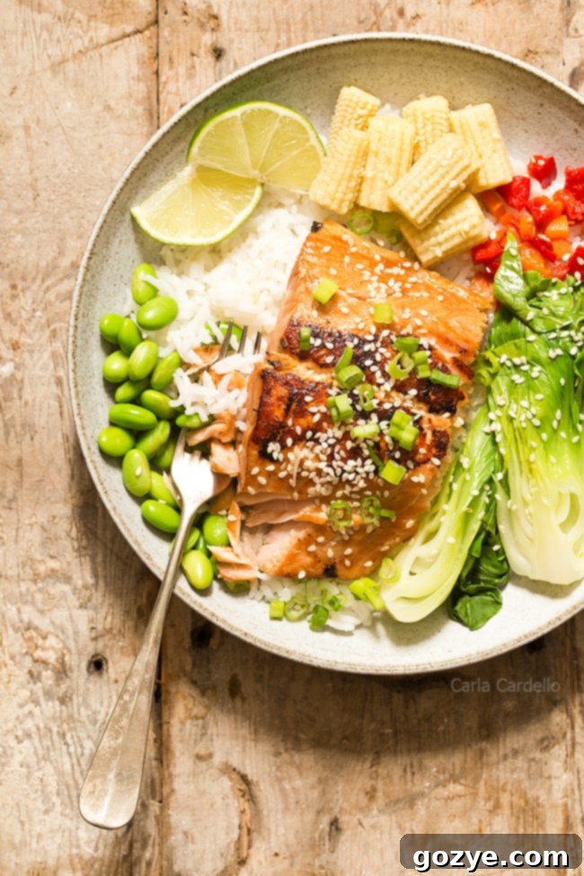 Ginger garlic salmon in bowl with fork