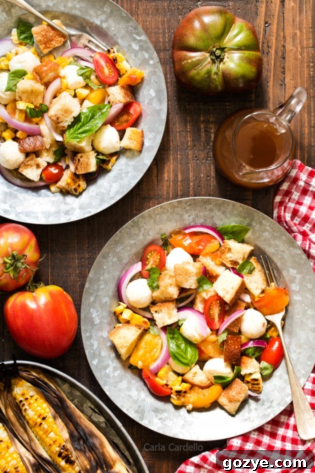 Vibrant Grilled Corn Panzanella Salad with tomatoes, mozzarella, basil, and homemade croutons, perfect for summer.
