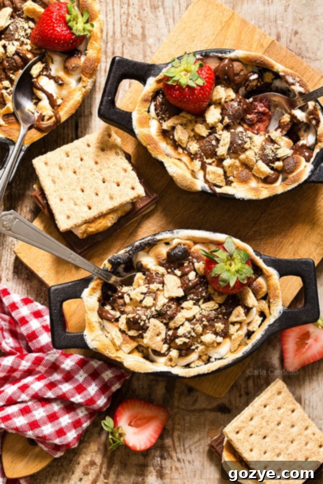 Oven-baked Strawberry S'mores Cobbler with a rich chocolate strawberry filling, topped with golden toasted marshmallows and crunchy graham cracker pieces. A perfect no-campfire s'mores dessert.