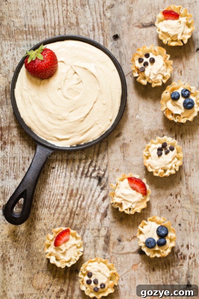 Make snack time more exciting with no bake mini Peanut Butter Fruit Dip Phyllo Cups made with marshmallow creme and Greek yogurt.
