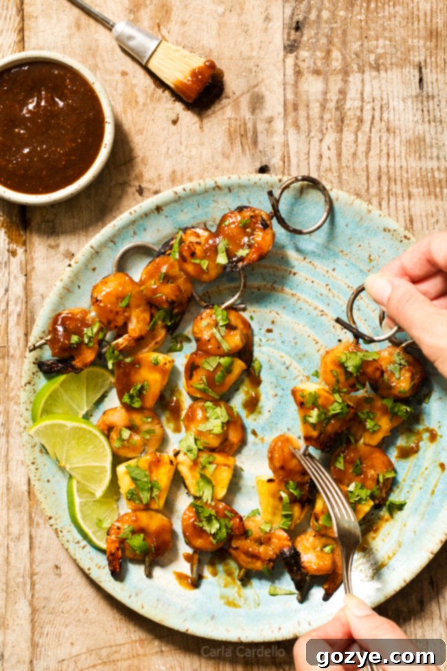 Grilled Pineapple Shrimp Teriyaki Kabobs on a grill, featuring succulent shrimp, vibrant pineapple, and a rich teriyaki glaze.
