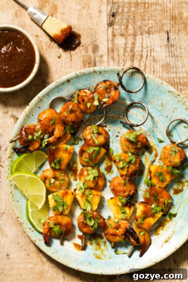 Close-up of succulent Grilled Pineapple Shrimp Teriyaki Kabobs on skewers, ready to be served.