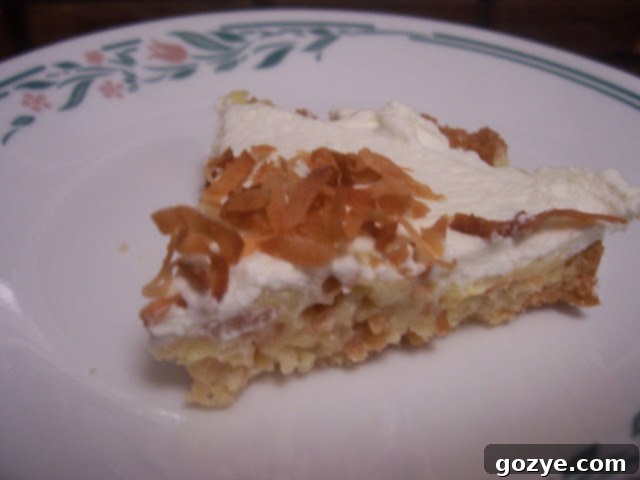 Close-up of a Toasted Coconut Custard Tart slice on a plate