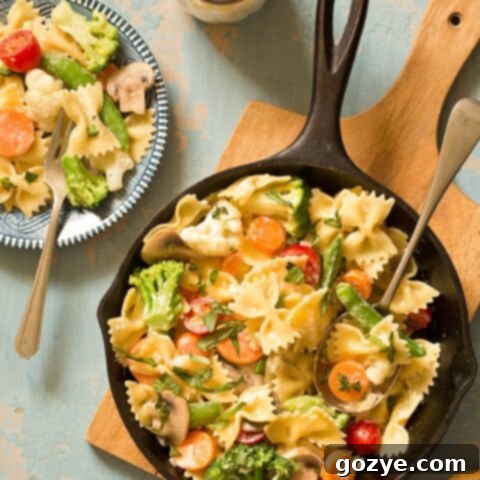 One Skillet Pasta Primavera with Creamy Parmesan Sauce, fresh vegetables, chicken and shrimp options for a customizable, easy dinner.