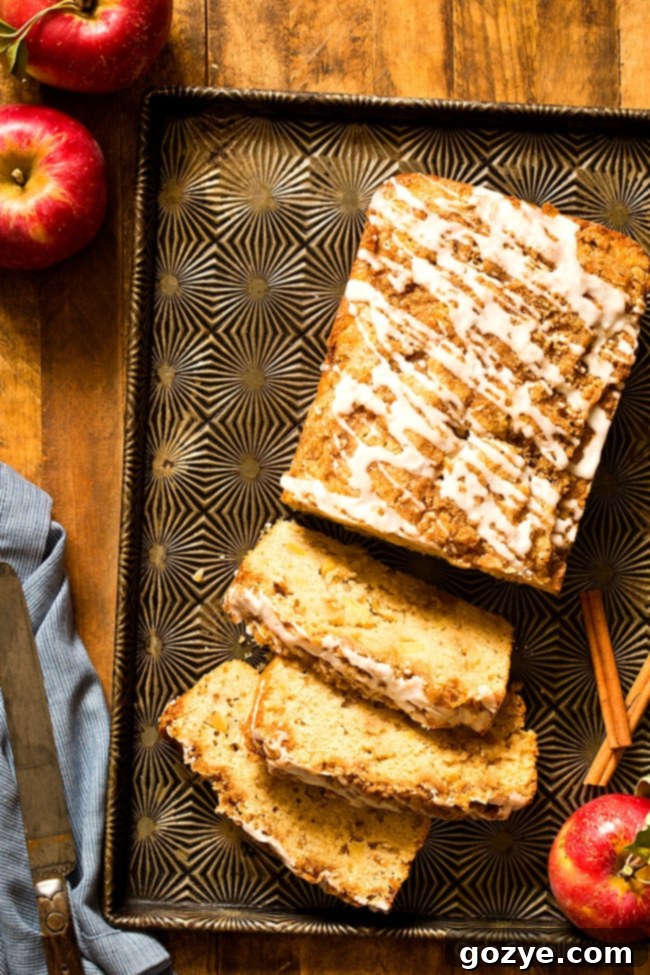 Close-up of a slice of Cinnamon Apple Bread, showing the streusel topping and moist apple-filled interior.