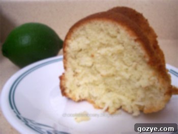 Close-up of a slice of moist lemon coconut cake with a glaze