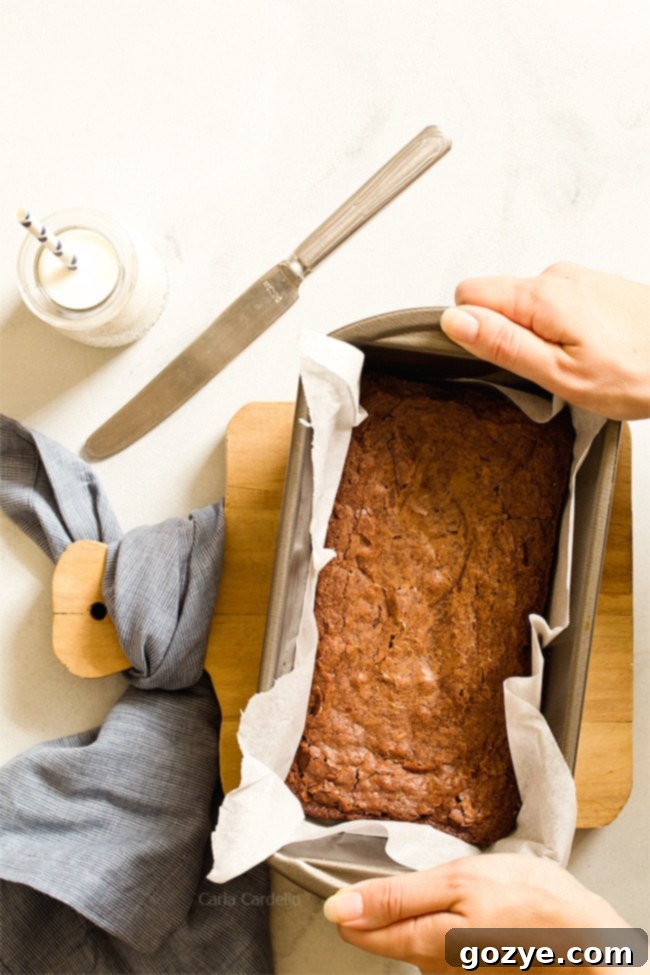 Small Batch Brownies in a loaf pan with parchment paper