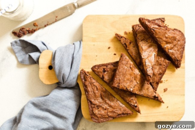 Small Batch Brownies cut into triangles on a cutting board