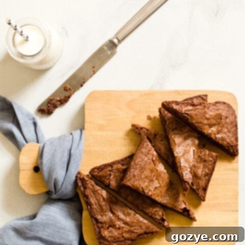 Small Batch Brownies cut into triangles on a cutting board