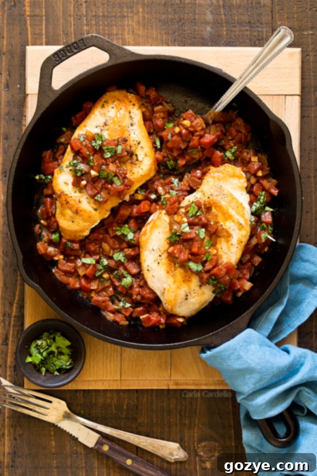 Chicken with tomatoes in cast iron skillet