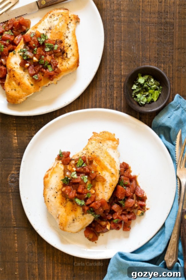 Chicken and tomatoes on white plate