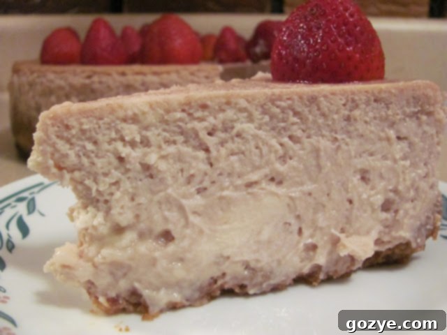 Close-up of creamy Strawberry White Chocolate Chip Cheesecake filling