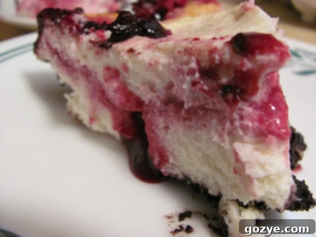 Beautifully swirled Black Raspberry Ribbon Cheesecake with an Oreo cookie crust