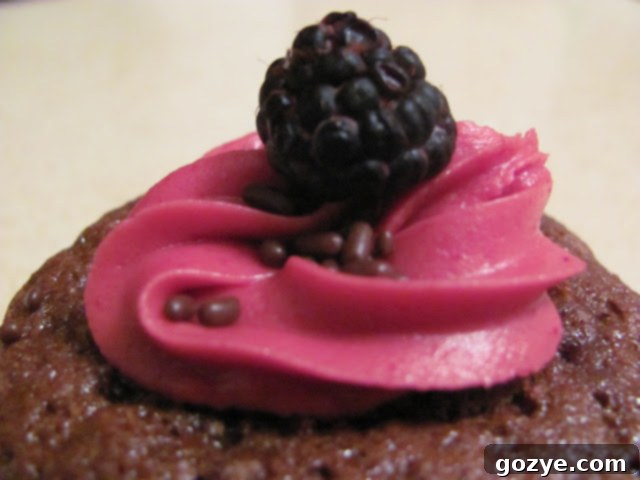 Chocolate cupcakes filled with black raspberry curd, ready for frosting