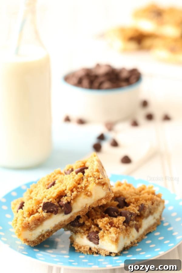 Three perfectly sliced Chocolate Chip Cookie Dough Cheesecake Bars arranged on a white plate, showcasing their inviting golden crust and rich layers.