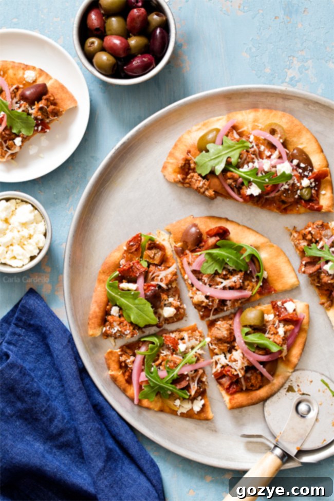 Put a Mediterranean twist on pizza night with Greek Pita Pizza! Top yours with ground lamb, olives, feta, pickled red onion, and arugula for an easy yet fulfilling meal.