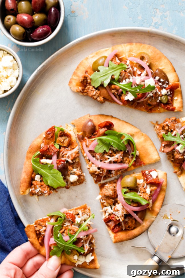 Put a Mediterranean twist on pizza night with Greek Pita Pizza! Top yours with ground lamb, olives, feta, pickled red onion, and arugula for an easy yet fulfilling meal.