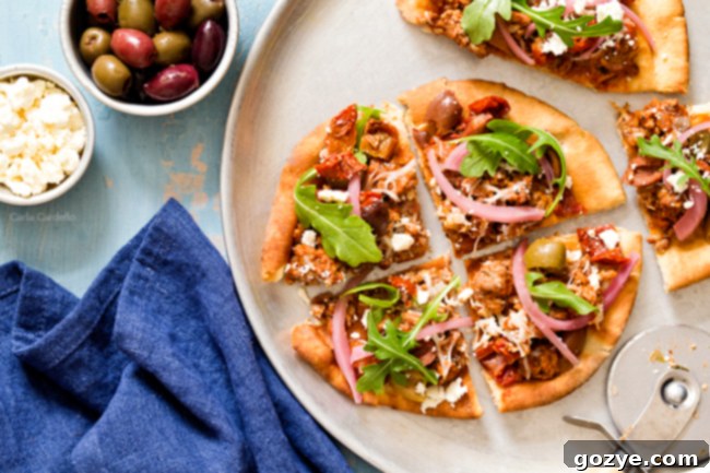 Put a Mediterranean twist on pizza night with Greek Pita Pizza! Top yours with ground lamb, olives, feta, pickled red onion, and arugula for an easy yet fulfilling meal.
