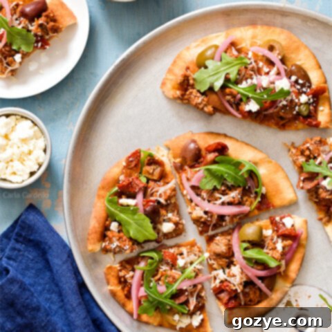 Put a Mediterranean twist on pizza night with Greek Pita Pizza! Top yours with ground lamb, olives, feta, pickled red onion, and arugula for an easy yet fulfilling meal.