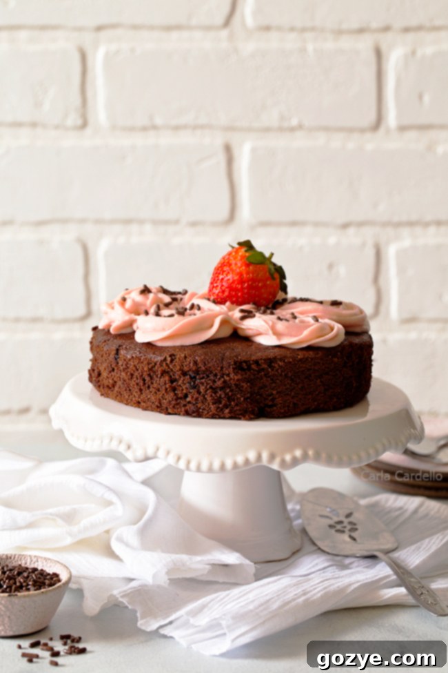 Small Chocolate Cake on a white cake stand, ready to be served