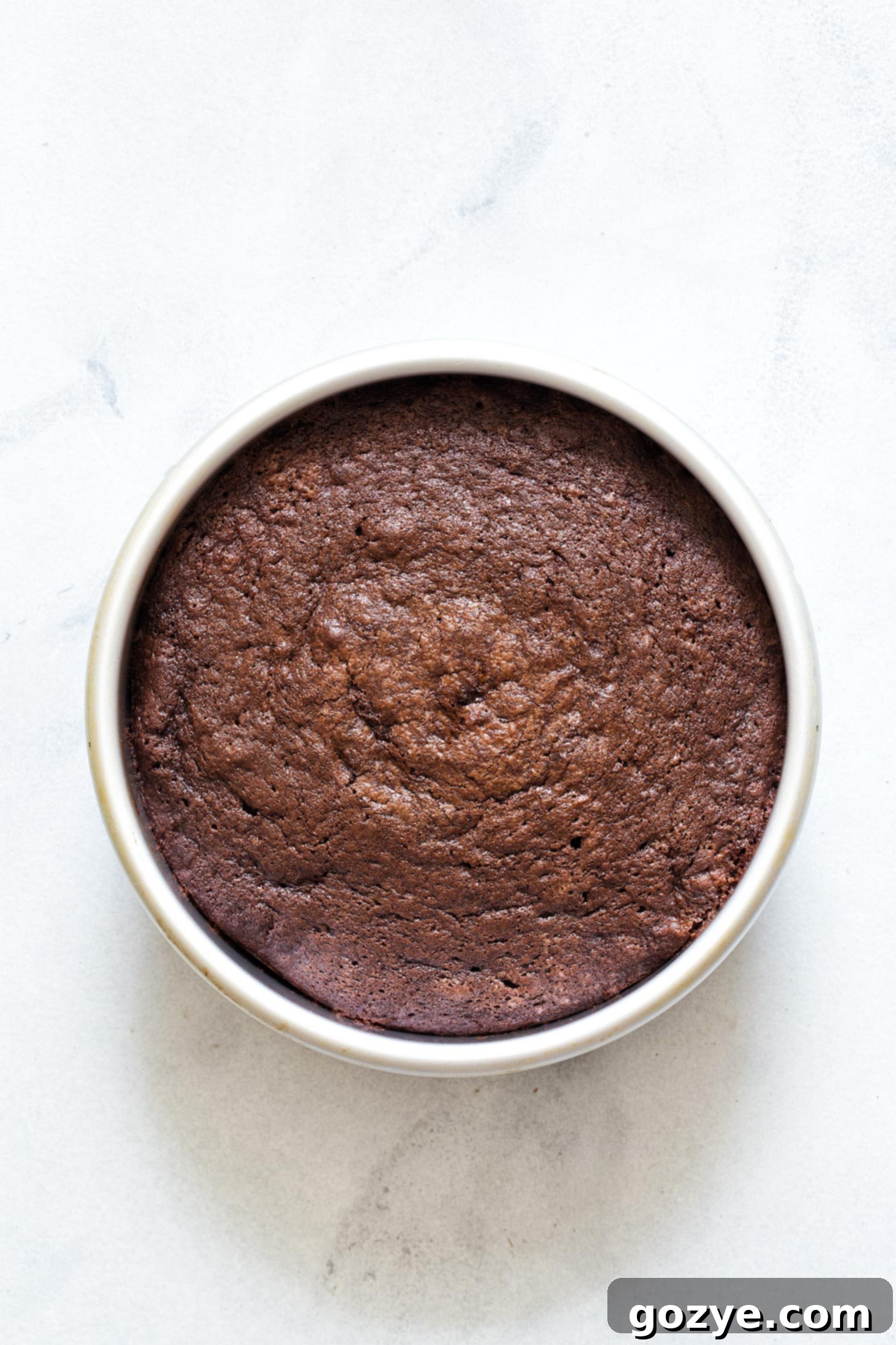 Freshly baked and cooled 6-inch chocolate cake, ready for frosting