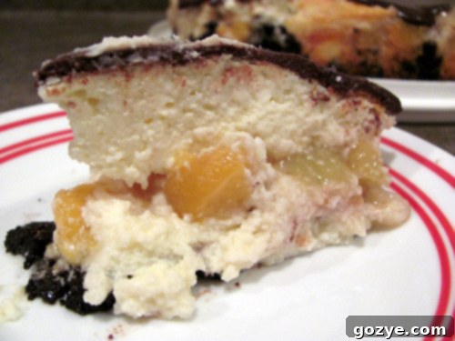Whole chocolate peach cheesecake with a glossy ganache topping