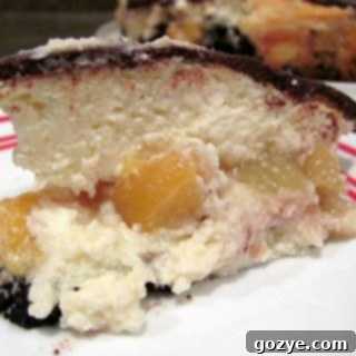 Chocolate Peach Cheesecake with a slice removed, showing layers