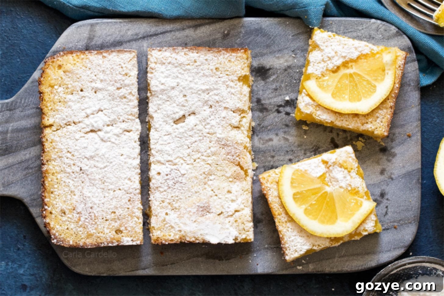 Zesty Small Batch Lemon Bars 4 Lemon bars perfectly cut into squares on a rustic wooden board, ready for serving