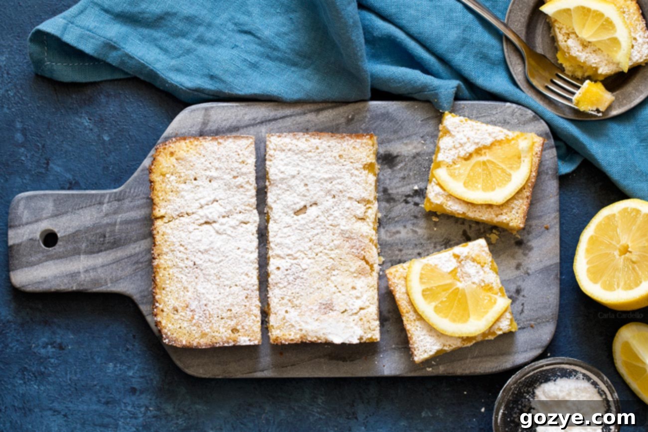Zesty Small Batch Lemon Bars 7 Another perspective of lemon bars neatly arranged on a cutting board, emphasizing their golden crust and creamy filling