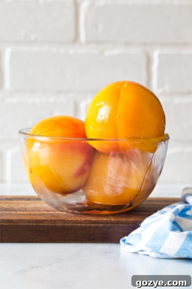 peeled peaches in a glass bowl