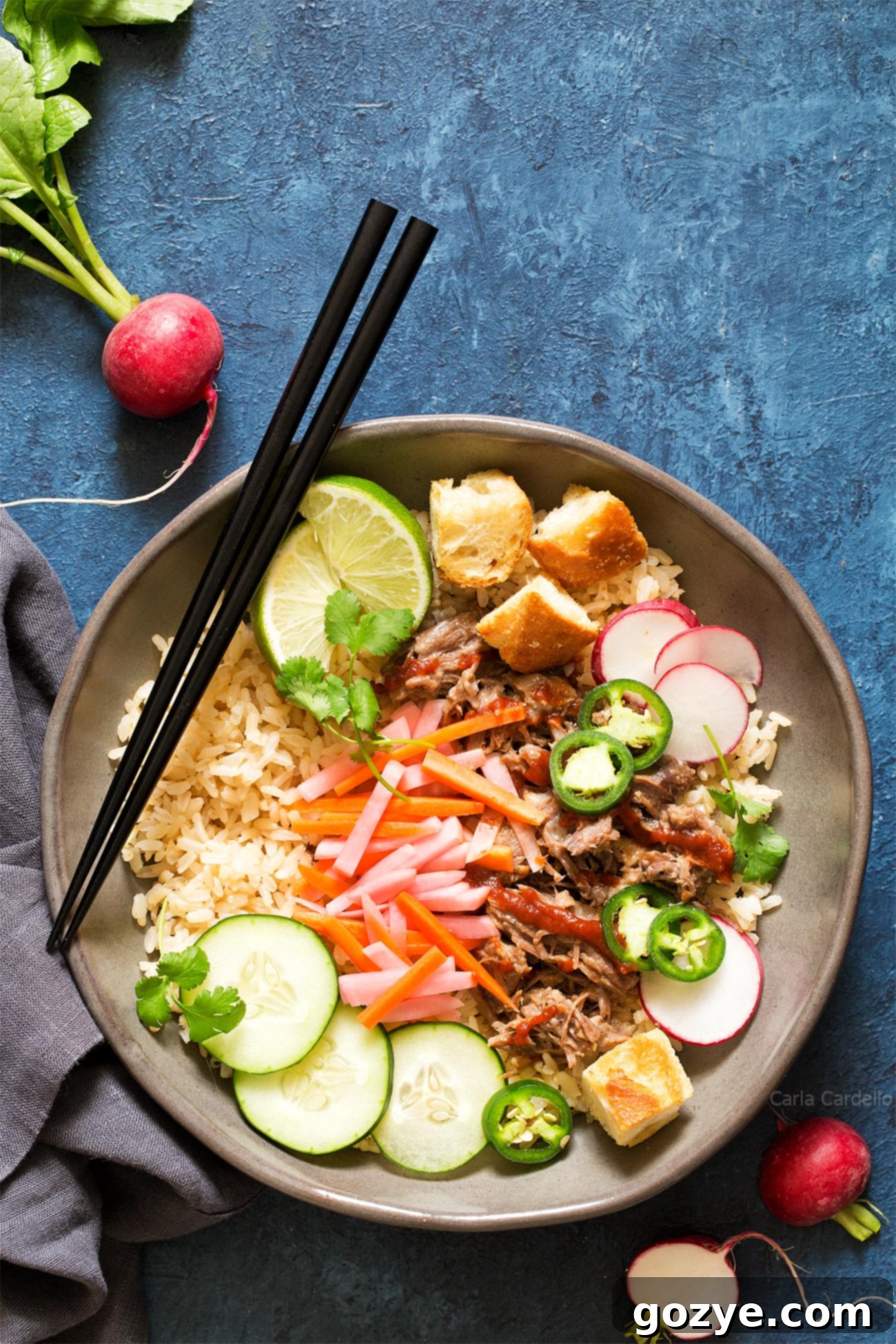 Slow Cooker Banh Mi Rice Bowls with tender pork, tangy pickled vegetables, and crunchy baguette croutons.