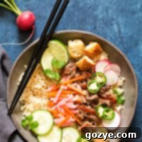 Slow Cooker Banh Mi Rice Bowls with pork, pickled vegetables, and baguette croutons.