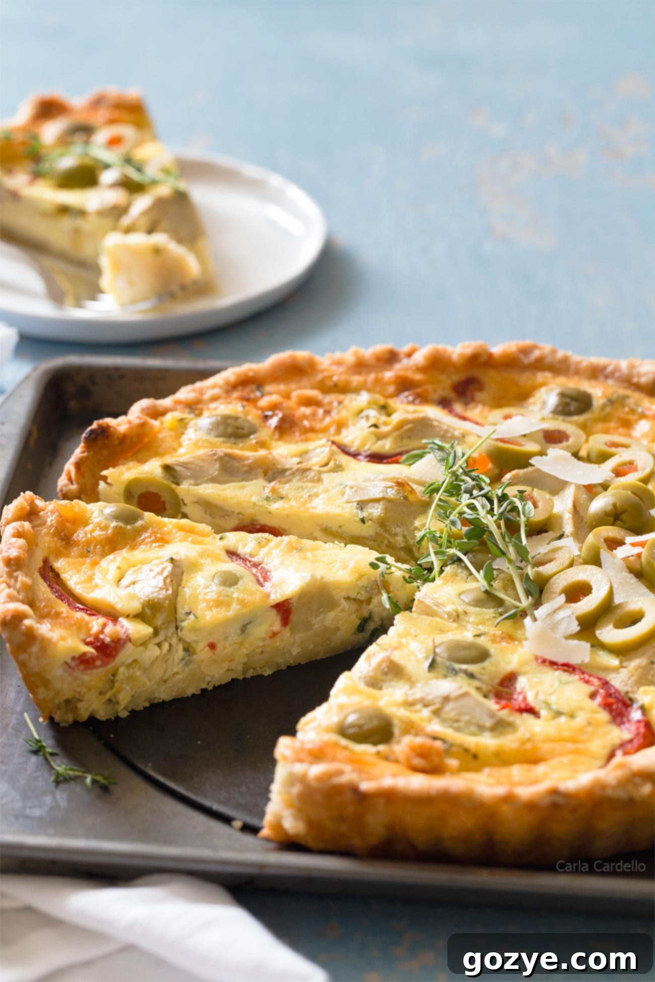A perfectly sliced piece of Vegetarian Artichoke Quiche showing the vibrant filling.