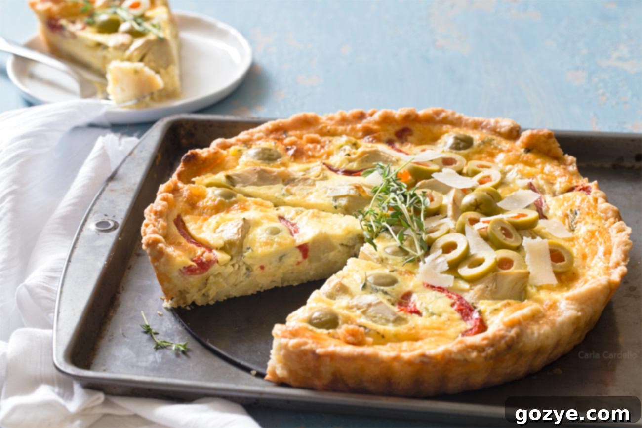 Close-up of baked Vegetarian Artichoke Quiche, with a slice missing, showcasing the delicious filling.