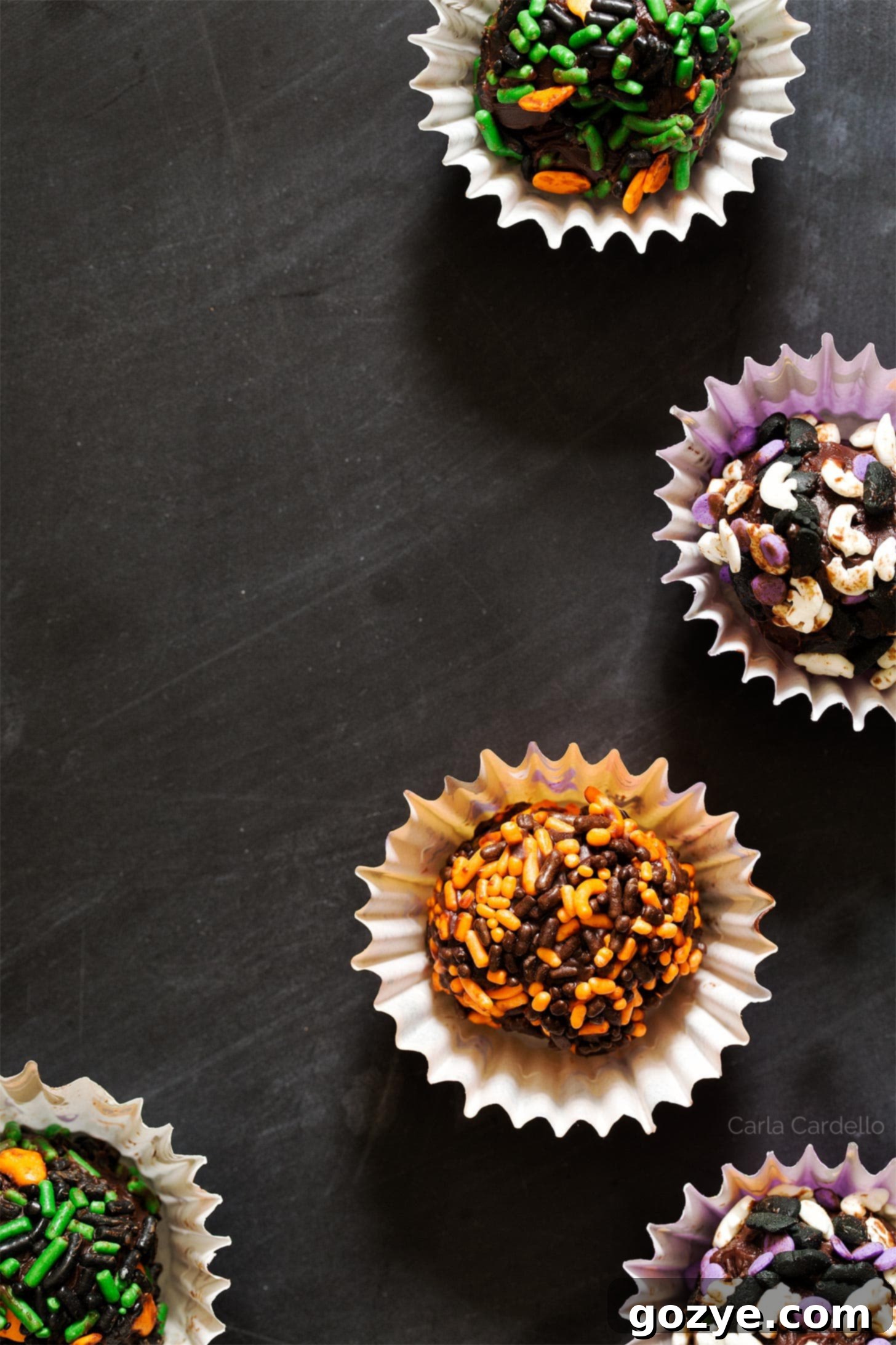 Close-up shot of chocolate ganache truffles beautifully coated with Halloween-themed sprinkles, ready to be enjoyed.