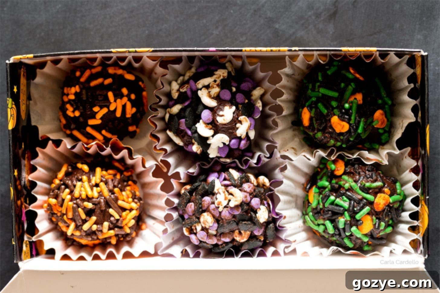 Homemade chocolate truffles neatly arranged in a small, elegant treat box, perfect for gifting.
