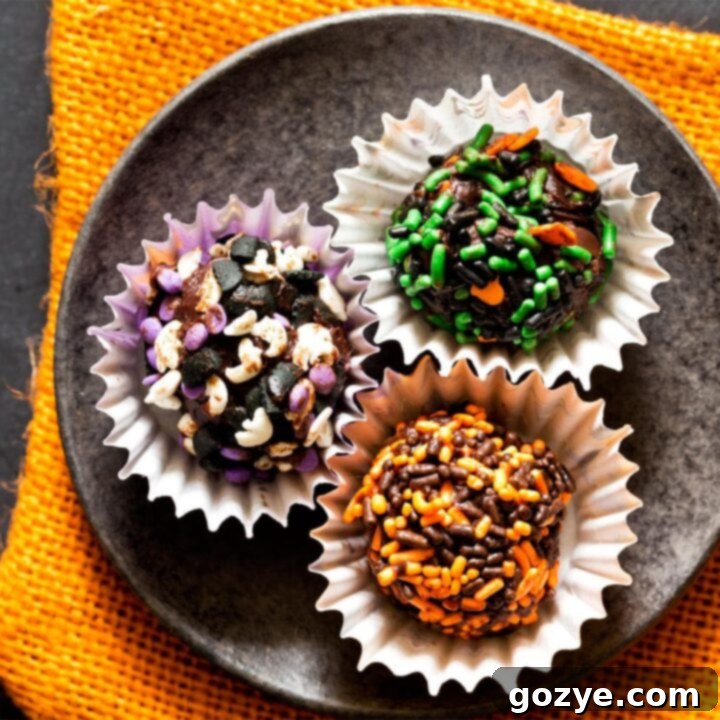 Close up of delightful Halloween truffles, glistening with chocolate and colorful sprinkles.