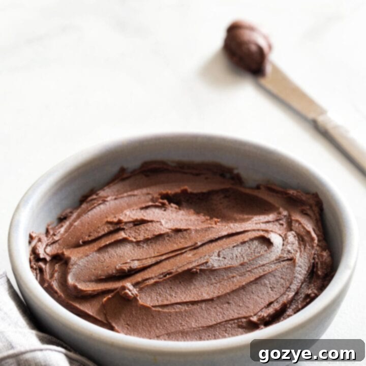 A delightful small batch of chocolate buttercream frosting in a bowl, ready for baking projects