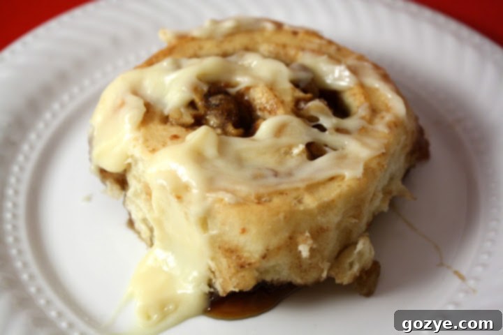 Apple Cider Cinnamon Rolls 4 Overhead shot of freshly baked Apple Cider Cinnamon Rolls arranged in a baking dish, beautifully frosted and ready to serve.