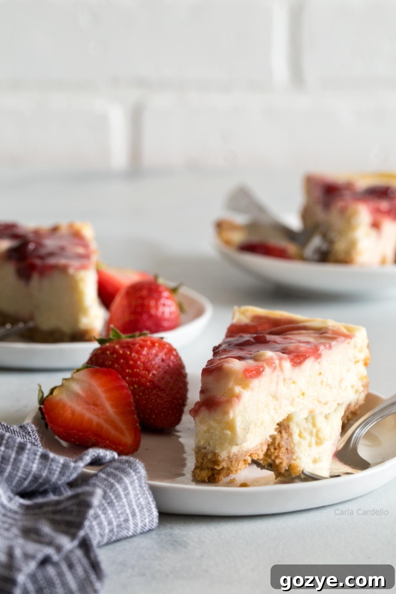 Slices of small batch cheesecake on plate with strawberries