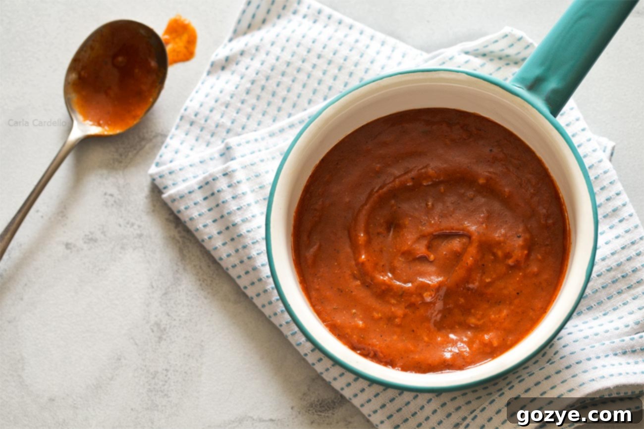 Close-up of small batch Homemade Red Enchilada Sauce, showcasing its rich texture and color, ready to be used for beef enchiladas