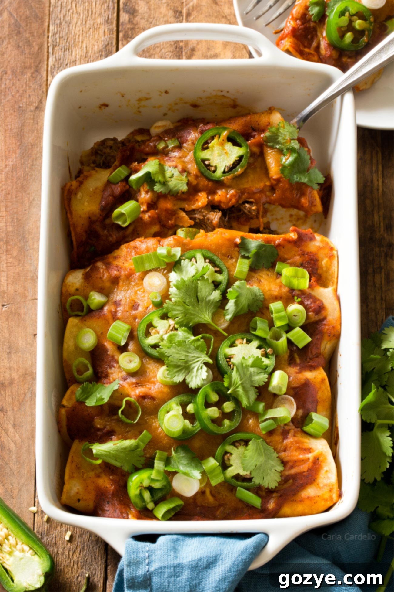 Beef Enchiladas in white casserole dish