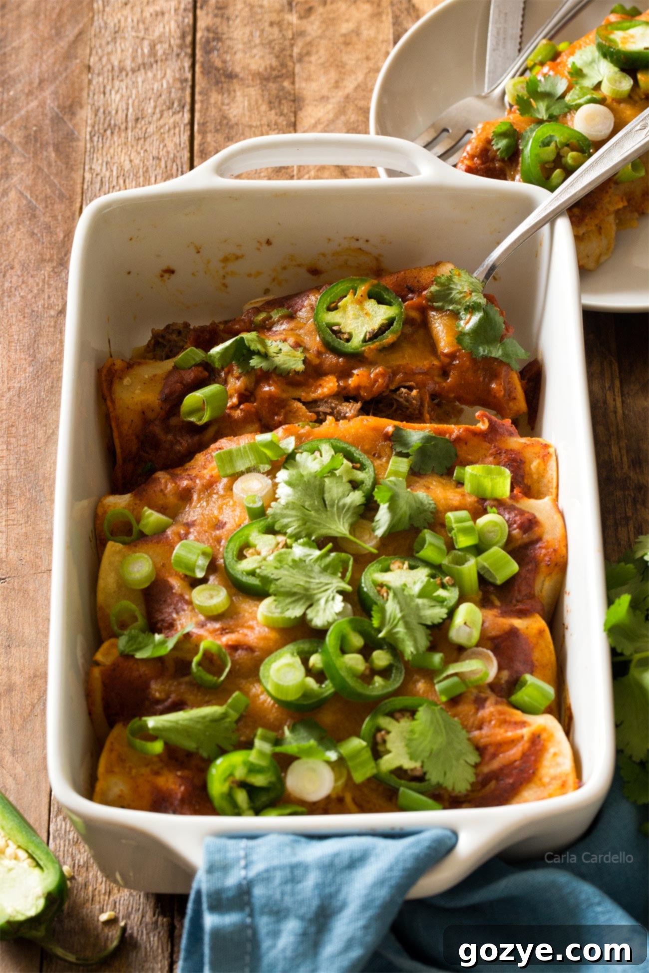 Beef Enchiladas in white casserole dish