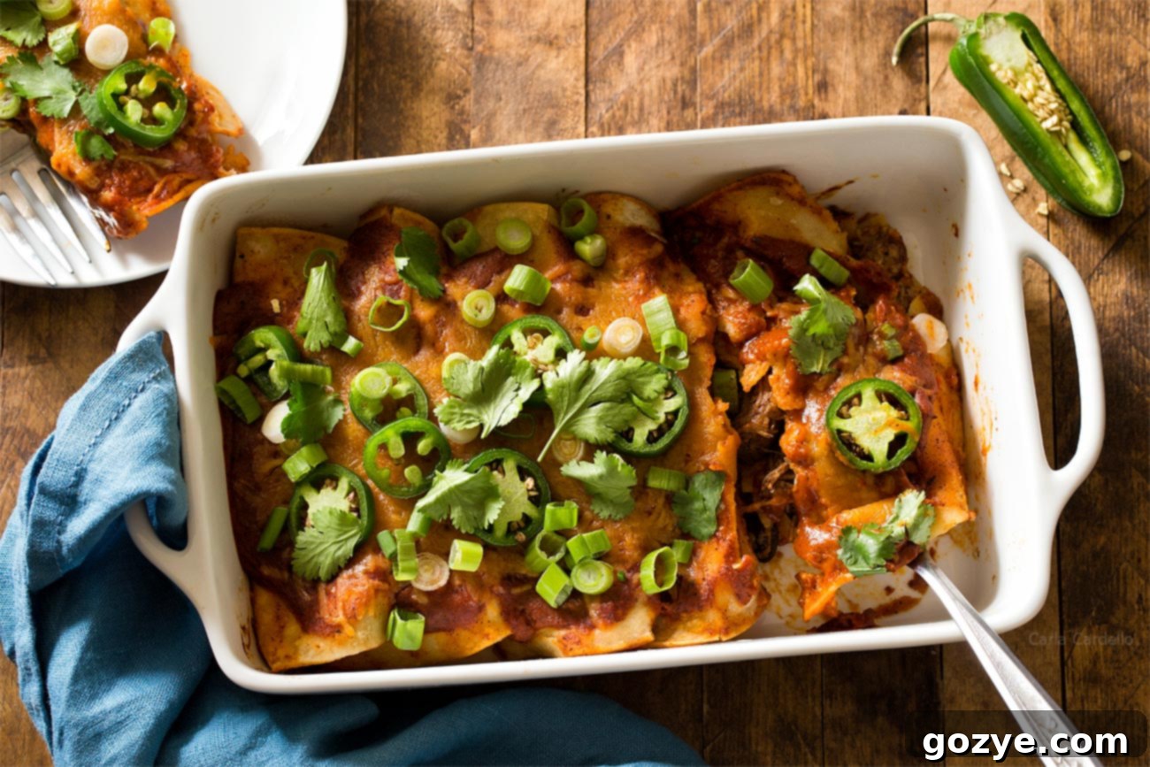 Beef Enchiladas in white casserole dish