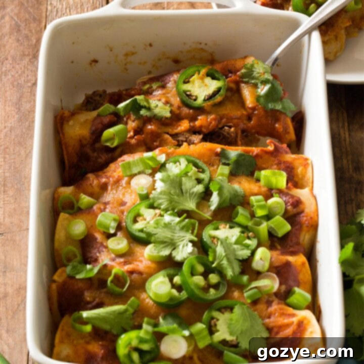 Beef Enchiladas in white casserole dish