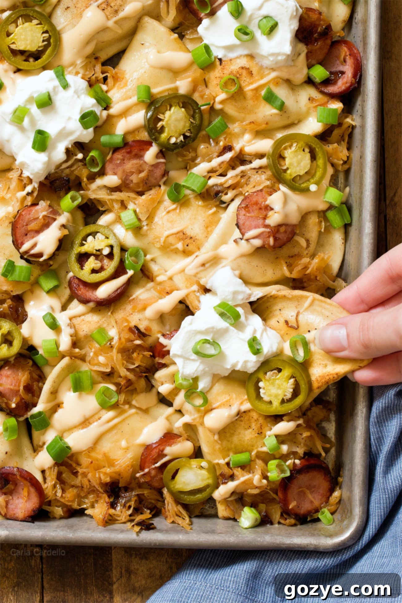 Overhead shot of Pittsburgh Pierogy Nachos with savory kielbasa, tangy sauerkraut, and creamy beer cheese